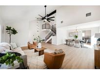 Bright living room featuring hardwood floors, vaulted ceilings and a cozy seating area at 602 Calcutta Ln, Henderson, NV 89015