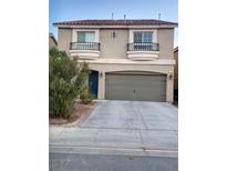 Two-story house with attached garage and balconies at 6059 Thistle Meadow Ave, Las Vegas, NV 89139