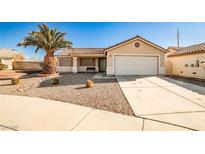 Single-story house with a two-car garage and desert landscaping at 6230 Home Haven St, North Las Vegas, NV 89031