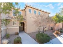 Two-story house with light brown exterior, landscaping, and walkway at 6255 W Arby Ave # 218, Las Vegas, NV 89118