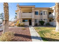 Two-story condo building with a walkway and landscaping at 1005 Sulphur Springs Ln # 202, Las Vegas, NV 89128