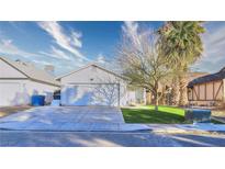 House exterior boasts a landscaped lawn, attached garage, and driveway at 1574 Teardrop St, Las Vegas, NV 89142