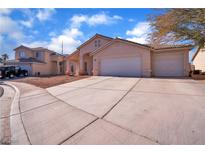 Two-story house with a three-car garage and landscaped yard at 2419 Country Valley Ct, North Las Vegas, NV 89030