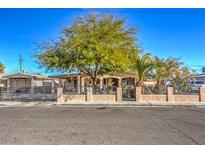 Ranch style home with mature trees and a gated front yard at 2608 Spear St, North Las Vegas, NV 89030