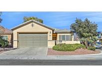 Single-story house with a two-car garage and landscaped front yard at 2812 Dotted Wren Ave, North Las Vegas, NV 89084