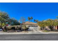 Single-story house with white garage door and desert landscaping at 301 Salinas Dr, Henderson, NV 89014