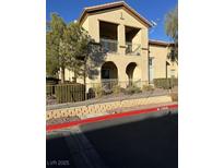 Two-story stucco building with balconies and arched entryways at 3810 Wiggins Bay St # 203, Las Vegas, NV 89129