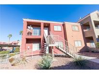 Two-story stucco building with stairs and desert landscaping at 4730 E Craig Rd # 2028, Las Vegas, NV 89115