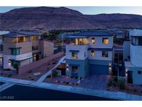Modern two-story home showcasing a unique design and inviting curb appeal amidst a mountain backdrop at 6289 Redstone Hills Dr, Las Vegas, NV 89148