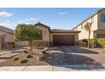 Single-story home with a two-car garage and well-manicured landscaping at 6333 Supernova Hill St, North Las Vegas, NV 89031