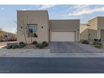 Modern home exterior featuring a two-car garage and manicured landscaping at 7017 Solana Ridge Dr, North Las Vegas, NV 89084