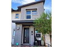 Modern two-story home with gray exterior and landscaped front yard at 724 Last Dance Pl, Henderson, NV 89011