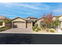 Two-story house with a three-car garage and landscaped front yard at 7576 Windy Meadow Ave, Las Vegas, NV 89178