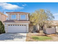 Two-story house with a two-car garage and landscaped yard at 7645 Rustic Galleon St, Las Vegas, NV 89139