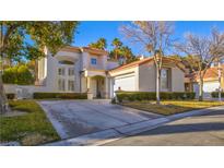 Two-story house with a large driveway and manicured landscaping at 8236 Horseshoe Bend Ln, Las Vegas, NV 89113