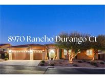 Stunning desert home with a 3-car garage and landscaped front yard at 8970 Rancho Durango Ct, Las Vegas, NV 89148