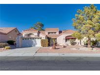 Single-story house with tile roof, attached garage, and landscaped yard at 9520 Sundial Dr, Las Vegas, NV 89134