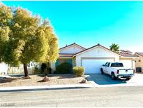 Single-story house with attached garage, landscaping, and driveway at 1060 Gallant Fox Ave, Henderson, NV 89015