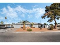 Ranch style home with landscaped yard and curb appeal at 4818 El Tesoro Ave, Las Vegas, NV 89121