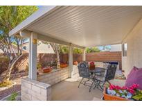 Covered patio with seating area, perfect for outdoor dining and relaxation at 5558 Leaning Cloud Ct, Las Vegas, NV 89113