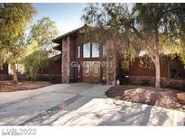 A charming two-story home with stone accents and a large front entrance at 5845 W Quail Ave, Las Vegas, NV 89118