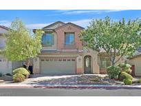 Two-story house with a green door and attached garage,landscaped yard at 8212 Opal Falls St, North Las Vegas, NV 89085