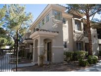 Two-story building exterior with Spanish-style architecture, landscaping, and walkway at 9050 W Warm Springs Rd # 2049, Las Vegas, NV 89148