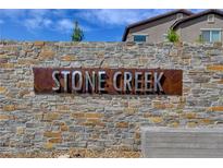 Stone Creek community entrance sign with modern metal lettering and stonework at 1610 Dire Wolf Avenue, North Las Vegas, NV 89084