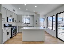 Modern kitchen with island, stainless steel appliances, and light gray cabinets at 2157 Wagonwheel Ave, Las Vegas, NV 89119