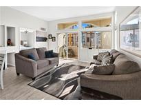 Bright living room with two sofas, large windows, and access to a patio at 3125 N Buffalo Dr # 2120, Las Vegas, NV 89128