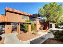 Spanish style building exterior with walkway, stairs and landscaping at 330 Shadybrook Ln # D, Las Vegas, NV 89107