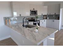 Modern kitchen with sleek cabinetry, quartz countertops, and stainless steel appliances at 3414 Mount Charleston Dr, Pahrump, NV 89048