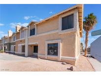 Tan two-story townhome with multiple windows and a small front yard at 3802 Terrazzo Ave, Las Vegas, NV 89115