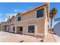 Two-story building exterior, featuring light-colored siding and landscaping at 3802 Terrazzo Ave, Las Vegas, NV 89115