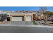 Single-story house with three-car garage and landscaped front yard at 5908 Aqua Verde St, North Las Vegas, NV 89031