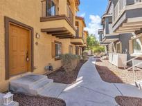 Charming condo featuring a private entrance with covered entryway and lovely exterior trim and landscaping at 5915 Nuevo Leon St # 7, North Las Vegas, NV 89031