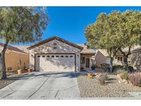 Single-story home with attached garage and landscaped front yard at 7933 Grey Teal St, North Las Vegas, NV 89084