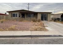 Ranch style home with a covered porch and a spacious yard at 1115 W Nelson Ave, North Las Vegas, NV 89030