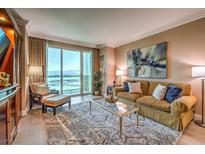 Bright living room featuring a large window, comfortable seating, modern decor, and neutral color palette at 135 E Harmon Ave # 2302, Las Vegas, NV 89109