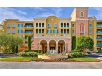 Elegant condo building with Spanish-style architecture, fountain, and lush landscaping at 30 Strada Di Villaggio # 151, Henderson, NV 89011