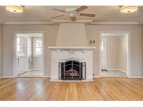Bright living room with hardwood floors, fireplace, and access to multiple rooms at 429 Ash St, Boulder City, NV 89005