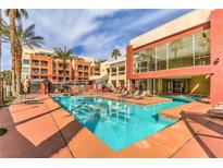 Beautiful community pool with lounge chairs surrounded by lovely landscaping, perfect for relaxation at 43 E Agate Ave # 403, Las Vegas, NV 89123