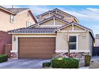 Two-story house with brown garage door and landscaped yard at 8115 Lennox View Ln, Las Vegas, NV 89113