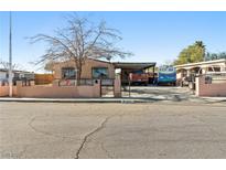 Ranch-style home with carport and gated front yard at 1215 Ferguson Ave, North Las Vegas, NV 89030