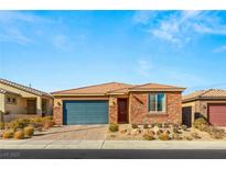 Single-story home with stone and neutral siding, a two-car garage, and desert landscaping at 1282 Paseo Del Oso Ln, Henderson, NV 89002