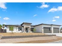 Stunning modern home with a three-car garage and landscaped front yard at 311 Belfast St, Henderson, NV 89015