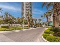 Luxury highrise building with palm trees and paved driveway at 322 Karen Ave # 1001, Las Vegas, NV 89109