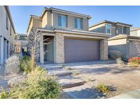 Two-story house with stone accents and a two-car garage at 355 Purple Sandpiper St, Las Vegas, NV 89138