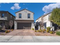 Two-story house with gray exterior, brown garage door, and landscaped front yard at 406 Misterioso St, Henderson, NV 89011