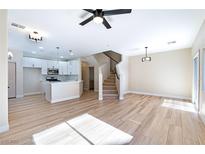 Bright living room with fireplace and wood-look floors at 6529 Za Zu Pitts Ave # 102, Las Vegas, NV 89122